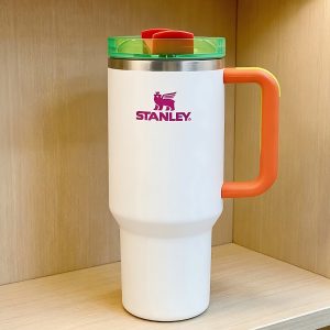 stanley 40oz tumbler | insulated cup with eye catching neon green & red accents & comfort grip handle, vacuum stainless steel, black